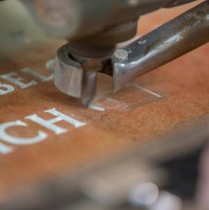 Precision-cut machine lettering on stone, showcasing clean lines and uniform depth.