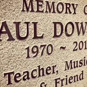 Close-up of reverse blast lettering on stone, where the background is sandblasted to leave raised, smooth letters in relief.