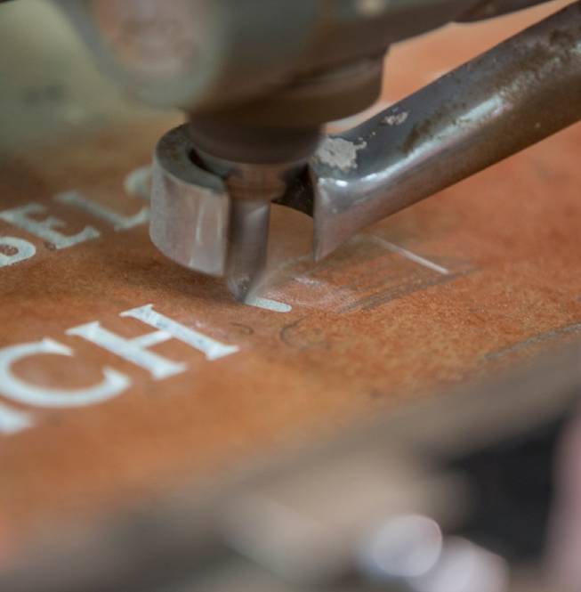 Precision-cut machine lettering on stone, showcasing clean lines and uniform depth.