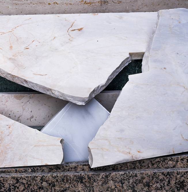 A fragmented piece of stone showcasing rugged, jagged edges and natural texture.