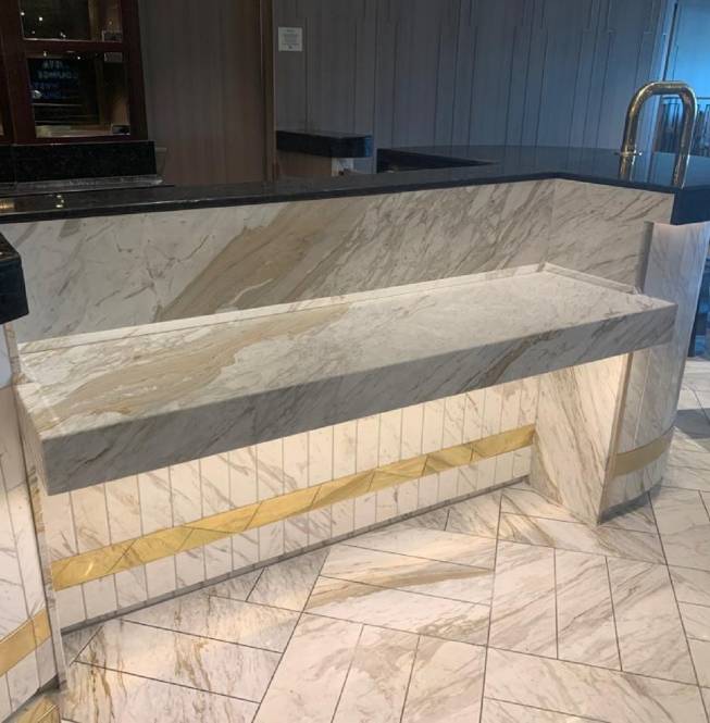 Custom-designed stone bar with lowered countertop for disabled access.